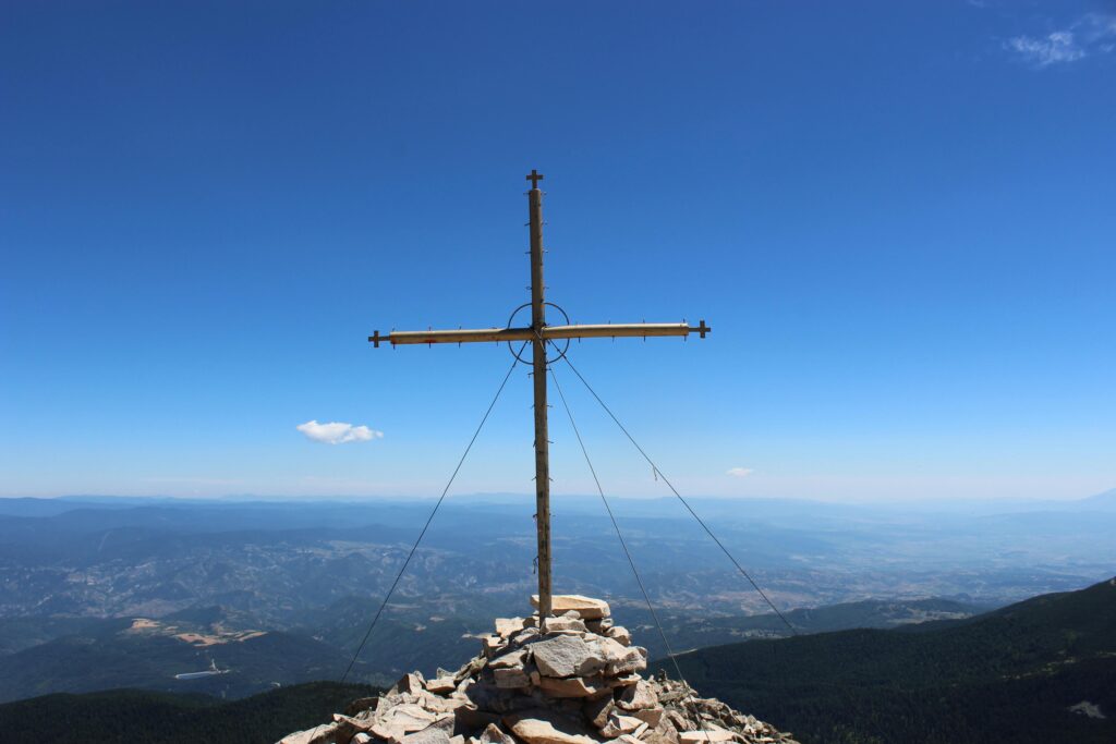 Stunning view of a cross on a mountain peak overlooking Blagoevgrad, Bulgaria.
