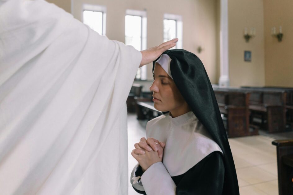 A nun receiving a blessing inside a church, displaying reverence and faith.